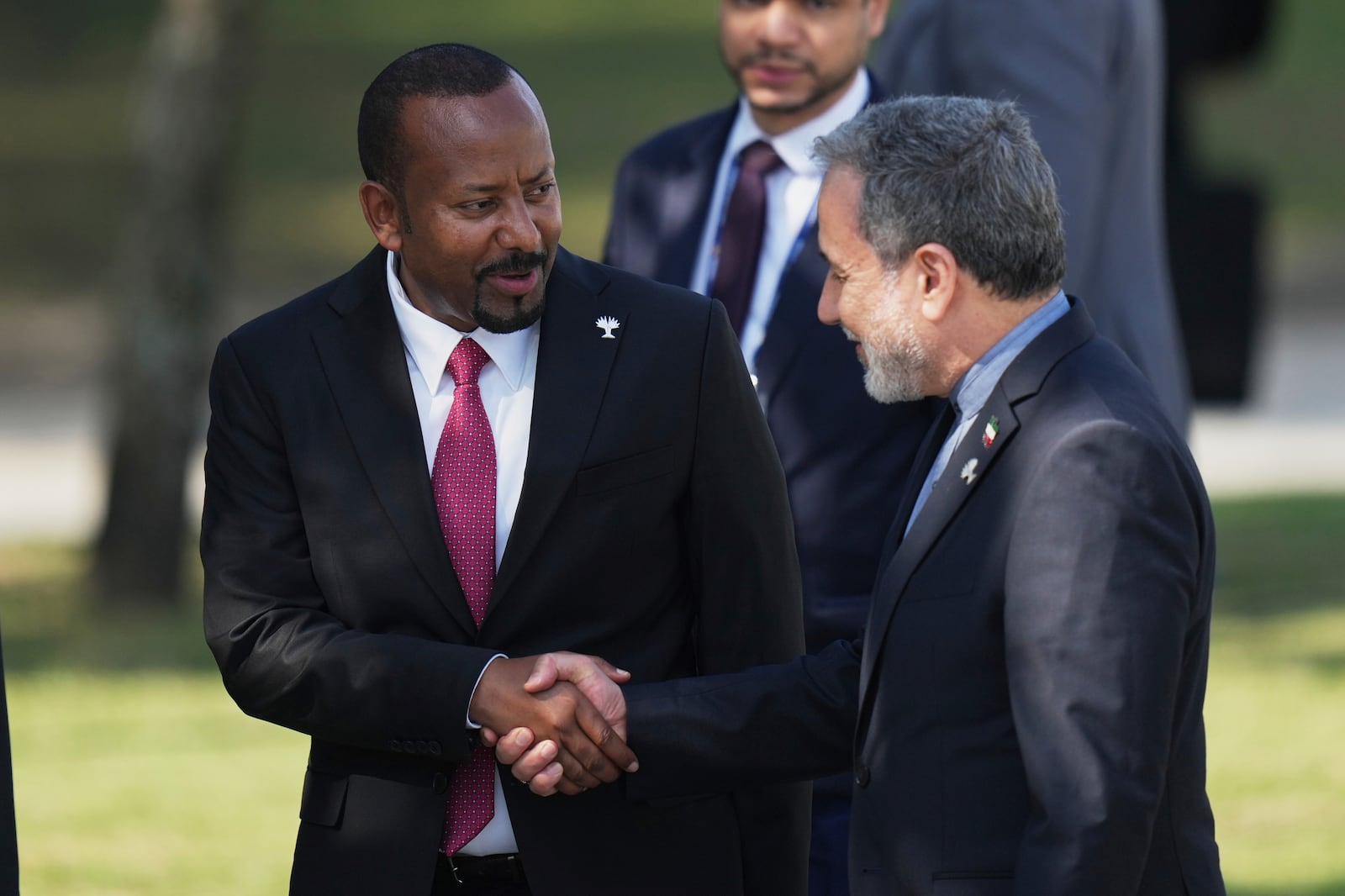 Prime Minister of the Federal Democratic Republic of Ethiopia Abiy Ahmed Ali, left, shakes hands with Iranian Foreign Minister Abbas Araghchi during the 17th annual BRICS summit in Rio de Janeiro, Sunday, July 6, 2025. (AP Photo/Silvia Izquierdo)