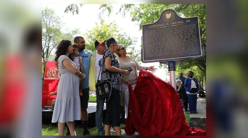 Miami University and Oxford city officials unveiled a new historic marker in an Uptown city park recognizing the racist legacy of lynching and mob violence against two local African American men. The 19th Century deaths are described on the marker and decedents of the two men are pictured here at the Monday unveiling ceremony. (Provided Photo\Journal-News)