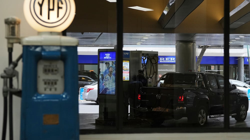 FILE - A worker fuels up a van at a YPF gas station in Buenos Aires, Argentina, July 14, 2025. (AP Photo/Rodrigo Abd, File)