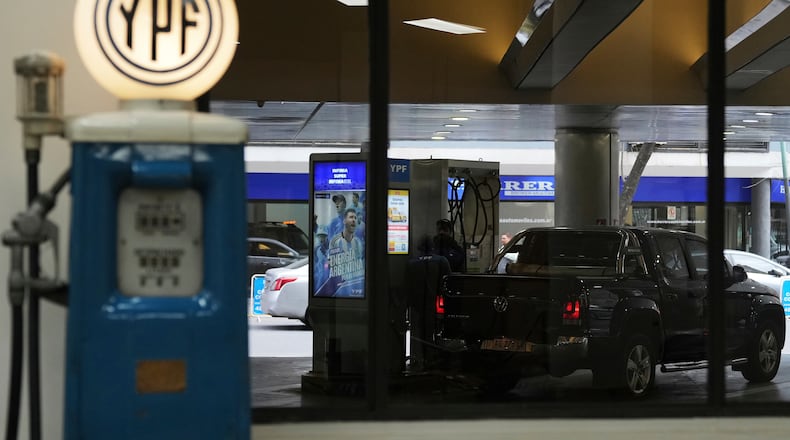 FILE - A worker fuels up a van at a YPF gas station in Buenos Aires, Argentina, July 14, 2025. (AP Photo/Rodrigo Abd, File)
