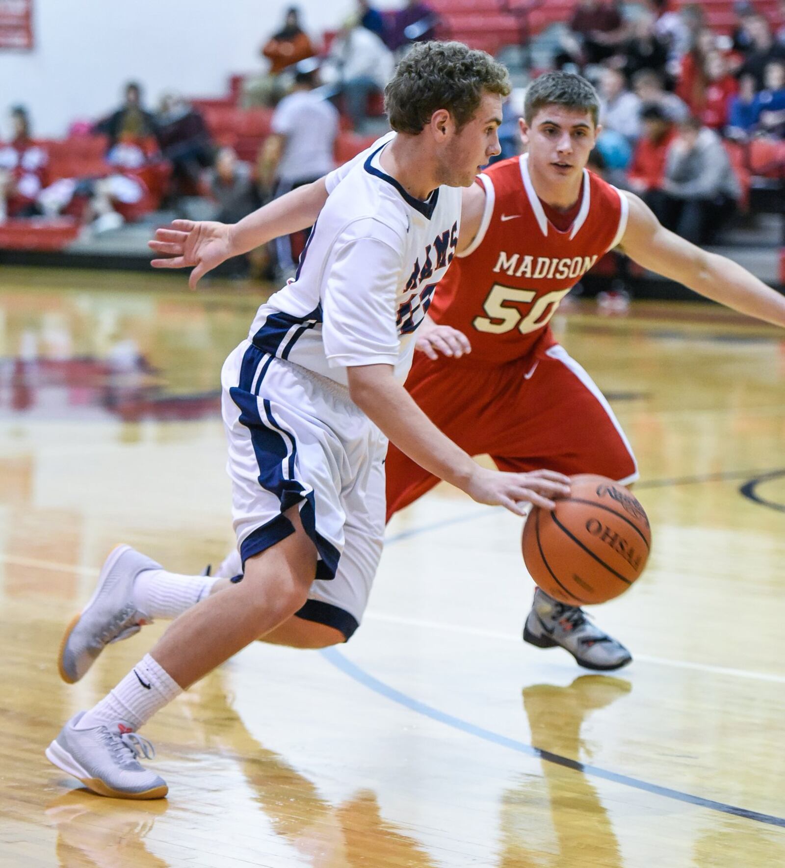 Miami Valley’s Alec Martin dribbles up the court as Madison’s Tyler Baumgartner provides the defense Thursday night during the Brian Cook Classic in Madison Township. NICK GRAHAM/STAFF