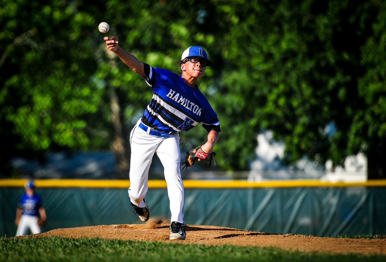 Hamilton West Side Little League’s Braedyn Moore delivers a pitch during a 10-0 victory over Lebanon on Monday in the District 9 tournament final at West Side. NICK GRAHAM/STAFF