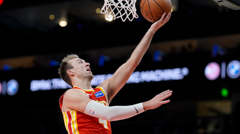 Atlanta Hawks guard Luke Kennard (4) shoots against the Indiana Pacers during the second half of an NBA basketball game, Monday, Jan. 26, 2026, in Atlanta. (AP Photo/Mike Stewart)