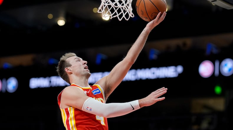 Atlanta Hawks guard Luke Kennard (4) shoots against the Indiana Pacers during the second half of an NBA basketball game, Monday, Jan. 26, 2026, in Atlanta. (AP Photo/Mike Stewart)