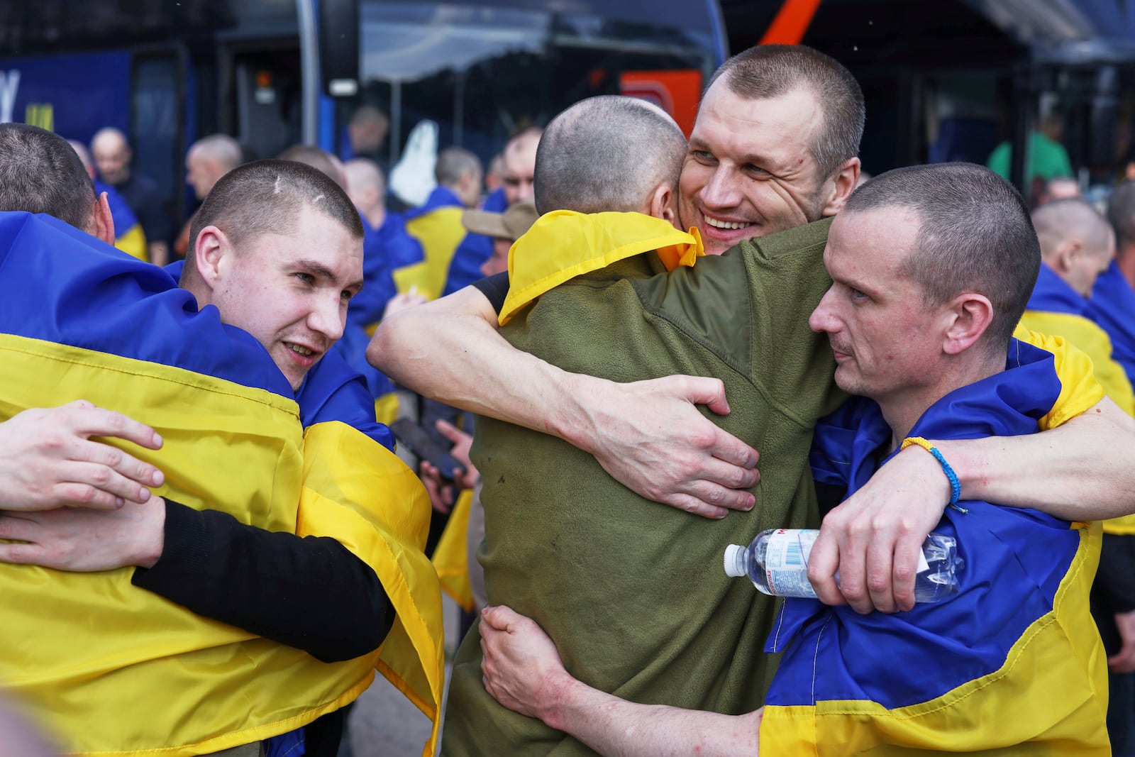 Ukrainian soldiers hug each other after returning from captivity following an exchange between Russia and Ukraine, in Chernyhiv region, Ukraine, Friday, May 23, 2025. (AP Photo)