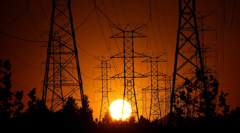 FILE - The sun sets behind high tension power lines, Monday, Sept. 23, 2024, in the Porter Ranch section of Los Angeles. (AP Photo/Mark J. Terrill, File)