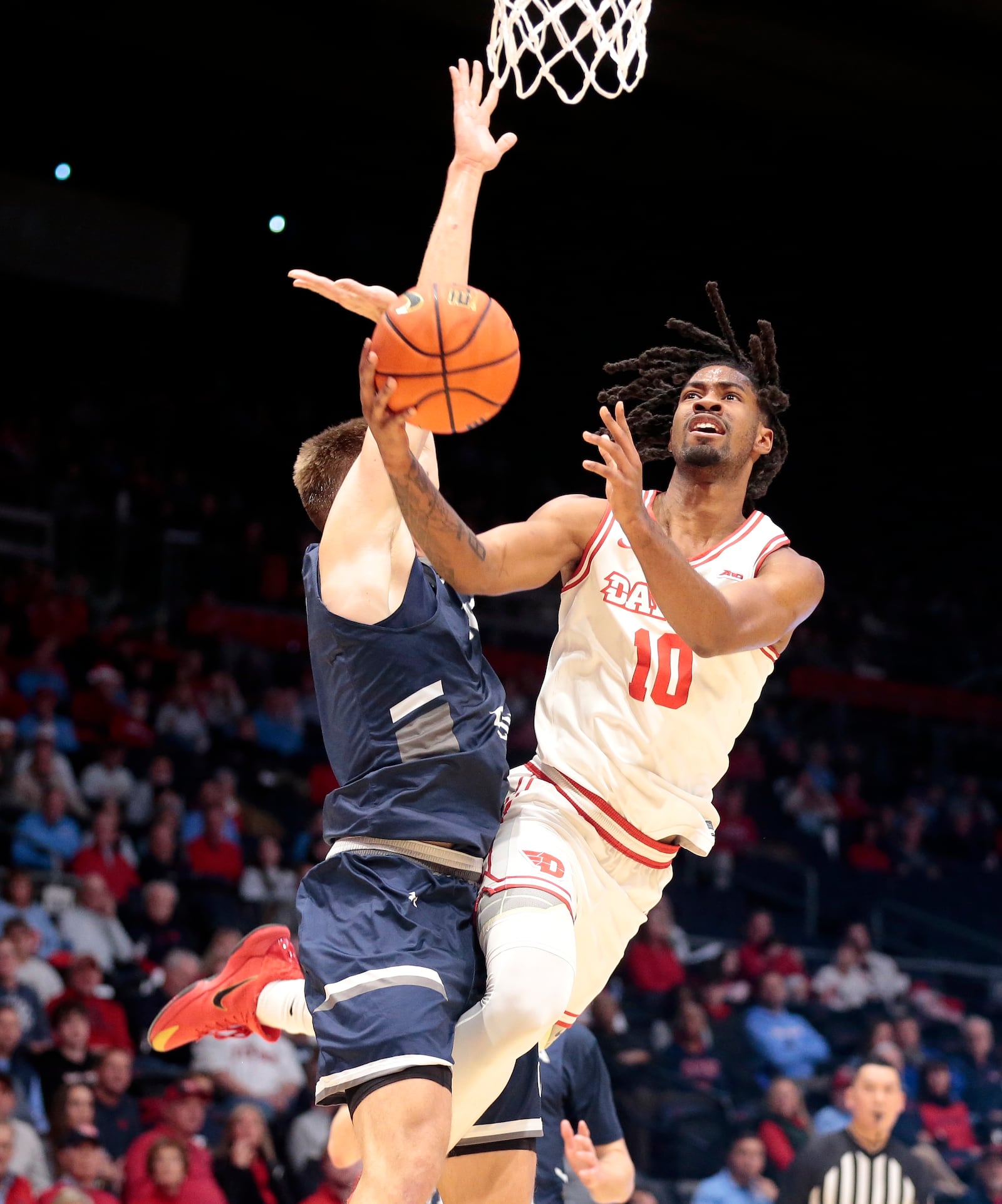Dayton's Bryce Heard tries to keep his balance on a shot attempt during a game against North Florida on Saturday, Dec. 13, 2025, at UD Arena. STEVEN WRIGHT / STAFF