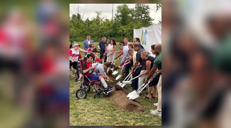 Local, county and state representatives join players and others turn the first shovels of dirt at the Adaptive Ball Fields at Makino Park in Mason, which will open in spring 2024. CONTRIBUTED