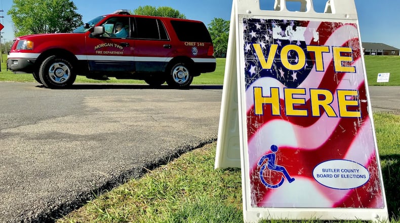 A Morgan Township Fire Department vehicle exits the Morgan Township Administration office complex during the primary election Tuesday, May 8. Morgan Township residents are voting on an increase millage EMS levy to pay for part-time salaries of firefighters, paramedics and EMTs. NICK GRAHAM/STAFF