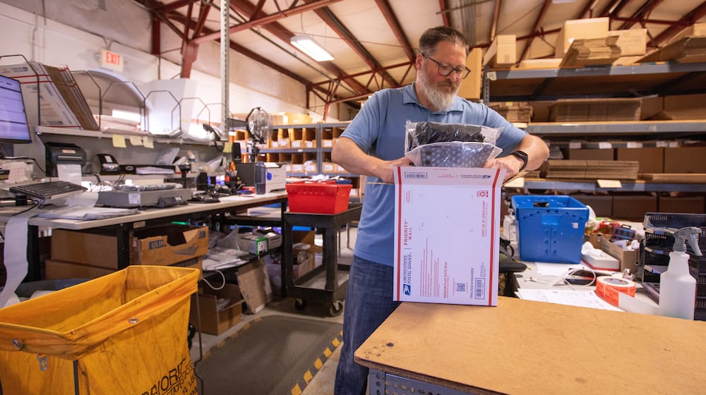 FILE - Terry Precision Cycling warehouse manager Luke Tremble packs orders at the company’s warehouse in Burlington, Vt., Tuesday, Oct. 28, 2025. (AP Photo/Amanda Swinhart, File)