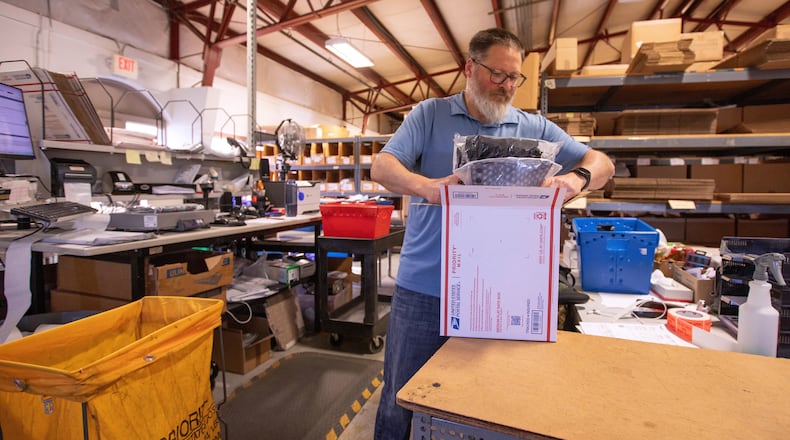 FILE - Terry Precision Cycling warehouse manager Luke Tremble packs orders at the company’s warehouse in Burlington, Vt., Tuesday, Oct. 28, 2025. (AP Photo/Amanda Swinhart, File)