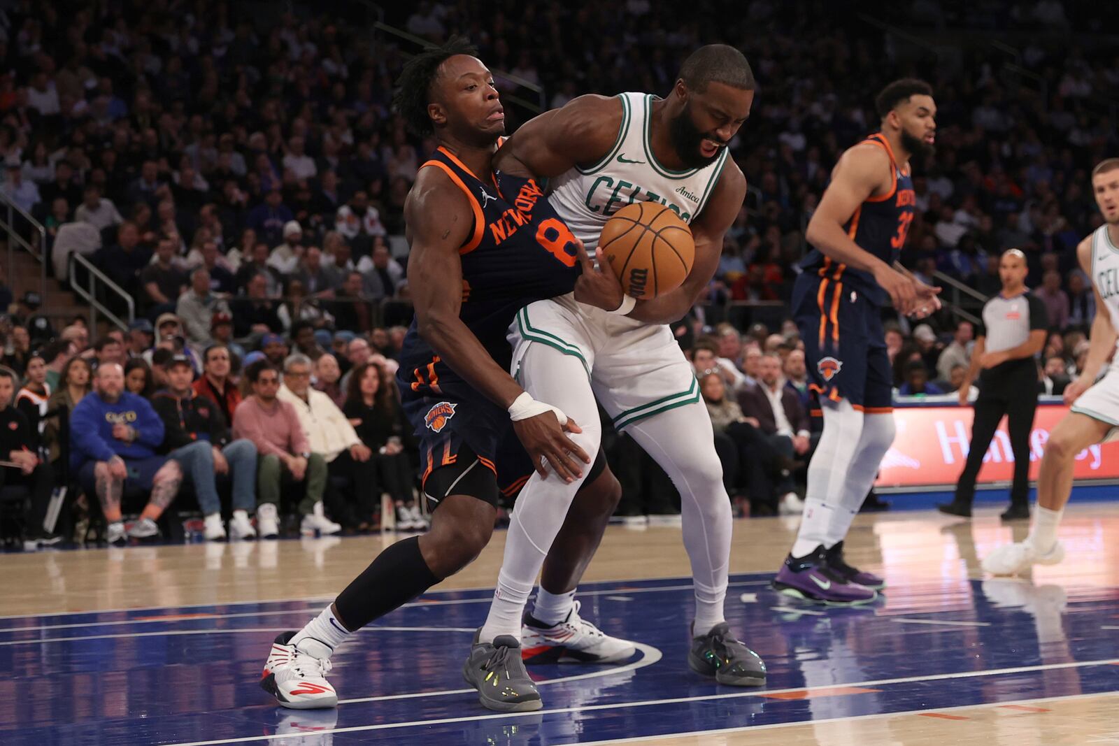 New York Knicks' OG Anunoby, left, and Boston Celtics' Jaylen Brown, right, fight for the ball during the second half of an NBA basketball game, Tuesday, April 8, 2025, in New York. (AP Photo/Pamela Smith)
