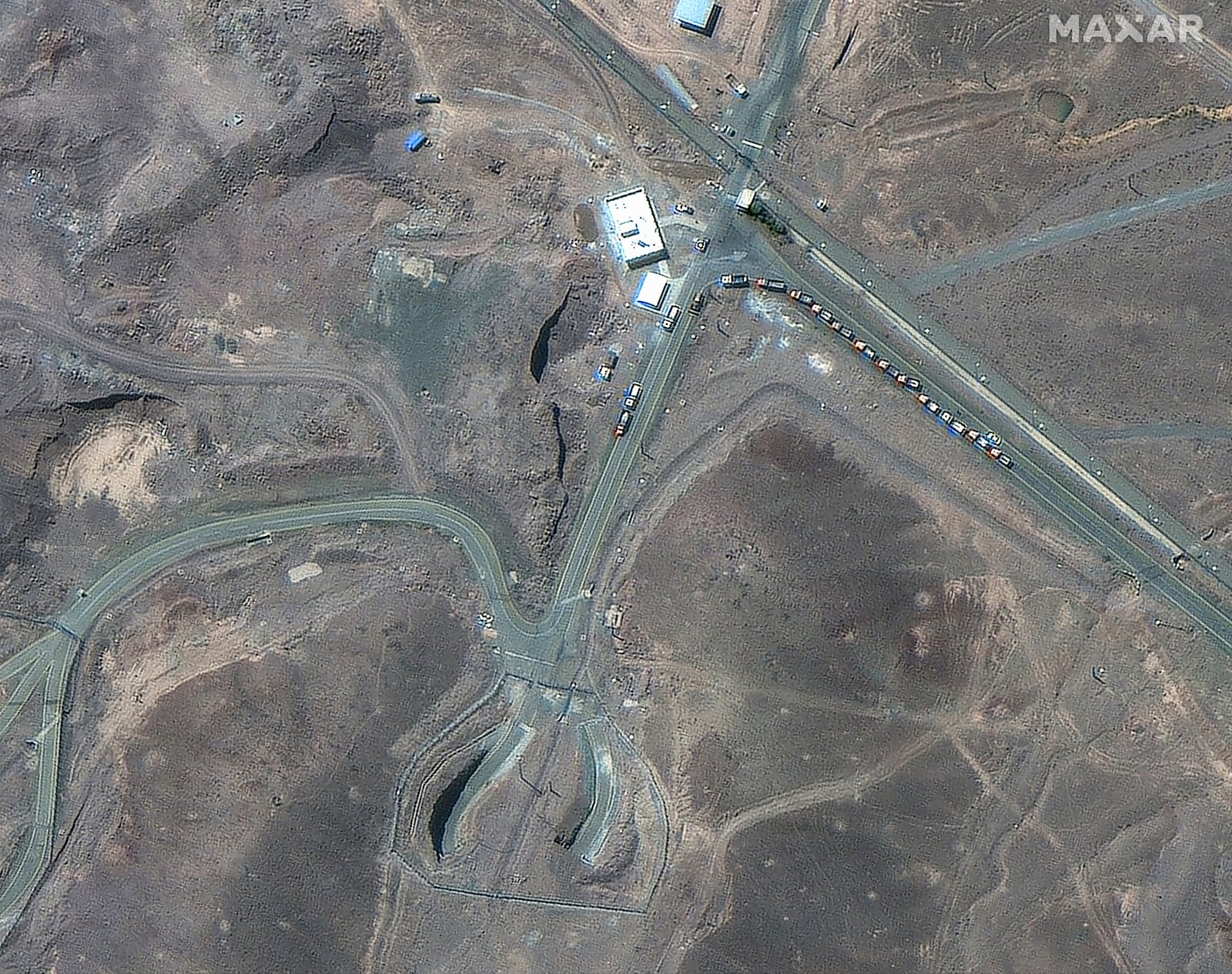This satellite image provided by Maxar Technologies shows vehicles at the Fordo enrichment facility in Iran on June 19, 2025. (Maxar Technologies via AP)