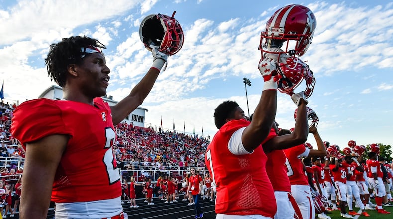 Fairfield’s Sawiaha Ellis (left) holds up his helmet as their game against Lakota West gets started Sept. 14 at Fairfield Stadium. The host Indians won 37-3. NICK GRAHAM/STAFF
