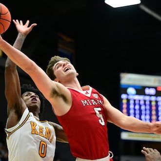 Miami (OH) RedHawks guard Peter Suder goes to the basket against Kent State forward Rayvon Griffith during the first half of an NCAA college basketball game, Tuesday, Jan. 20, 2026, in Kent, Ohio. (AP Photo/David Dermer)