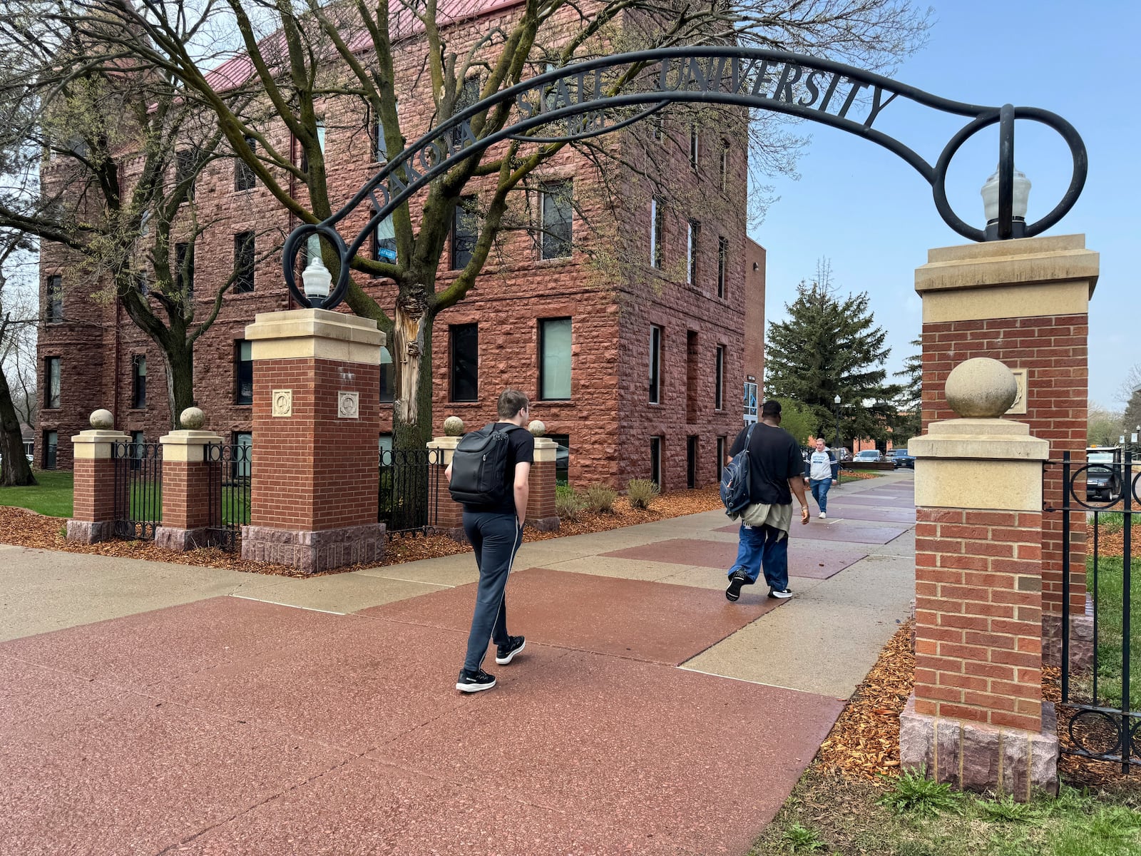 Students walk to class at Dakota State University, Monday, April 28, 2025, in Madison, S.D. (AP Photo/Sarah Raza)