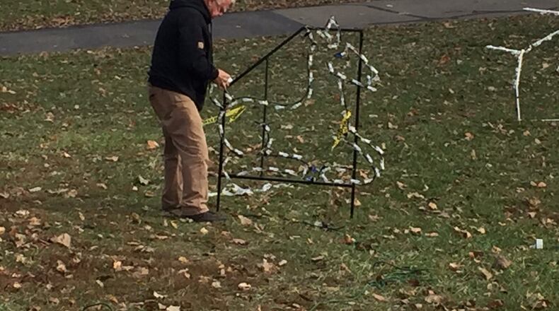 Don Owens, a retired Middletown police lieutenant and a member of the Grandpa Gang, was checking the wiring and bulbs of one of the many displays for Light Up Middletown on Tuesday. ED RICHTER/STAFF