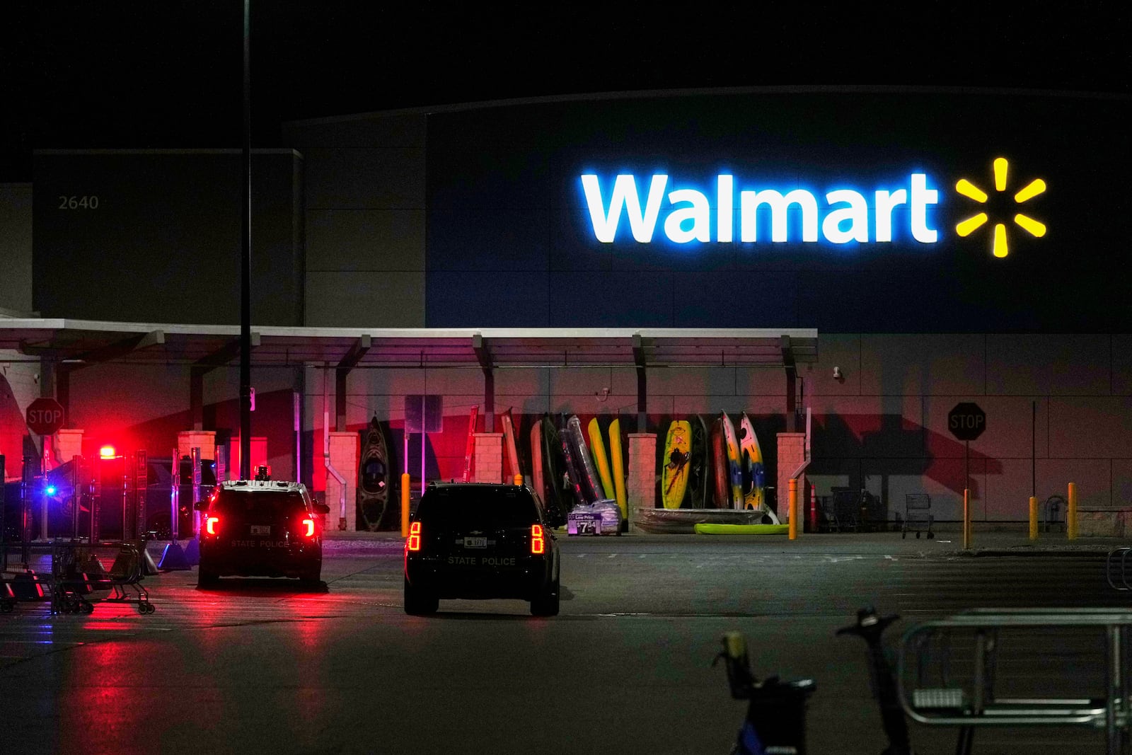 Law enforcement officers are seen stationed outside a Walmart where 11 people were stabbed in a violent attack Saturday, July 26, 2025, in Traverse City, Mich (AP Photo/Ryan Sun)