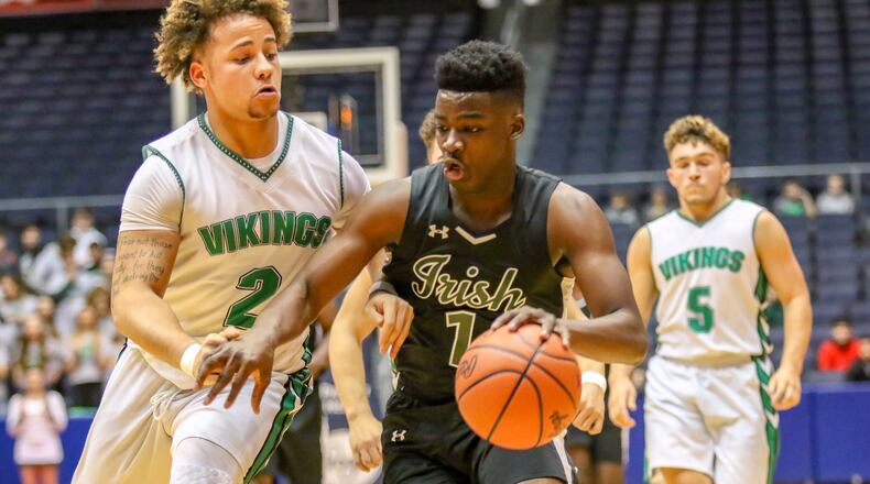 Springfield Catholic Central’s Mykah Eichie drives to the hoop against New Miami’s David Cunningham during their Division IV district basketball final Friday night at the University of Dayton Arena. Catholic Central won 71-63. CONTRIBUTED PHOTO BY MICHAEL COOPER