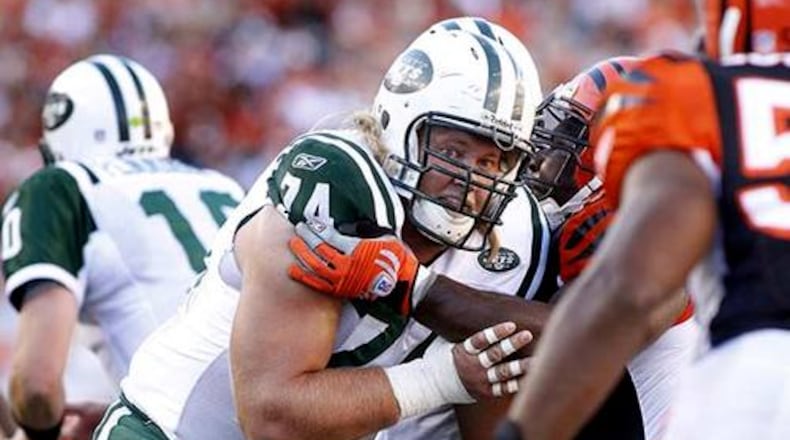 Nick Mangold, the starting center on the Jets offensive line, blocks for the Jets. Mangold graduated from Alter High School and played for Ohio State.