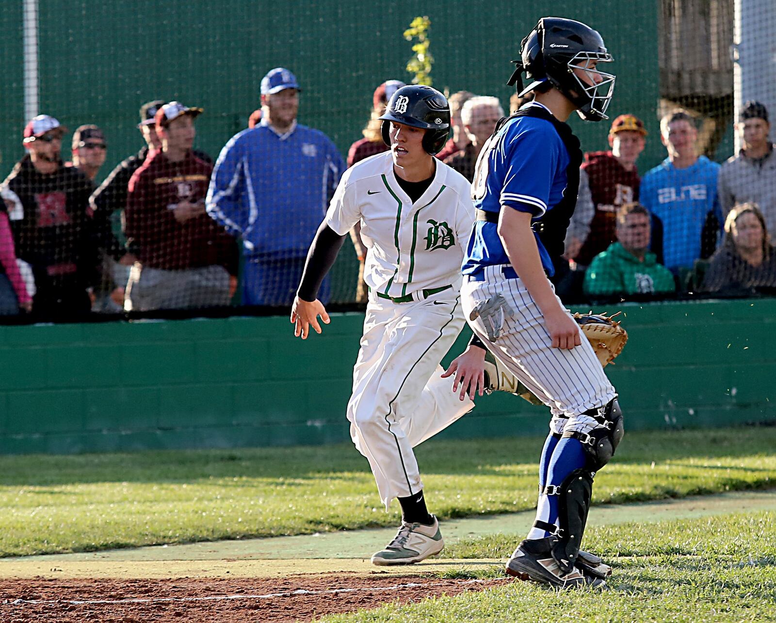 Badin’s Devon Valentino scores behind Hamilton catcher Zach Bell during Saturday night’s game at Alumni Field in Hamilton. CONTRIBUTED PHOTO BY E.L. HUBBARD