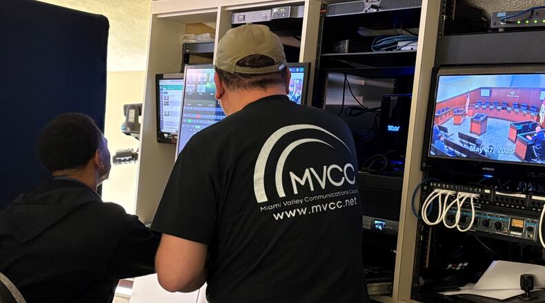 Miami Valley Communications Council technicians Evan Russell, left, and Mike Sopronyi prepare equipment for the Tuesday evening, May 27, 2025, Kettering City Council meeting. Council members on Tuesday unanimously approved a merger between MVCC and Miami Valley Educational Computer Association to form a new organization, the Miami Valley Technology and Communication Group. JEN BALDUF/STAFF