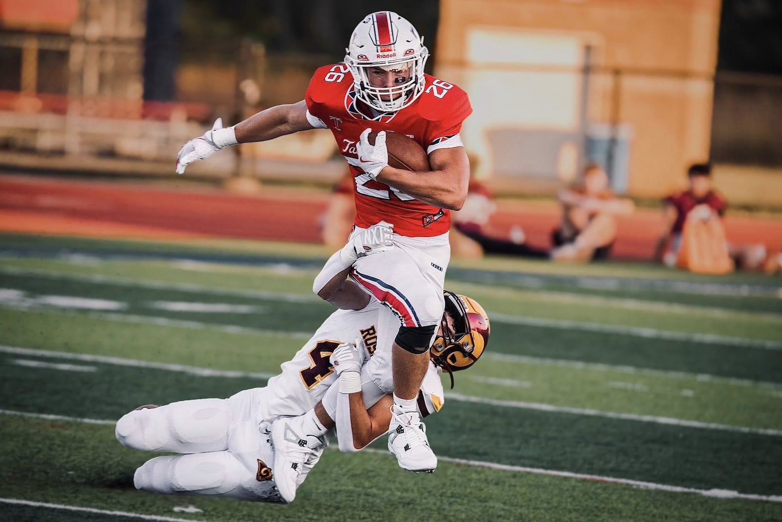 Talawanda running back Lance Cantrell is tackled by Ross defender Alex Galante during a recent game. JORDAN PHILLIPS / CONTRIBUTED