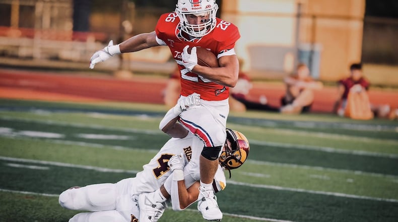Talawanda running back Lance Cantrell is tackled by Ross defender Alex Galante during a recent game. JORDAN PHILLIPS / CONTRIBUTED