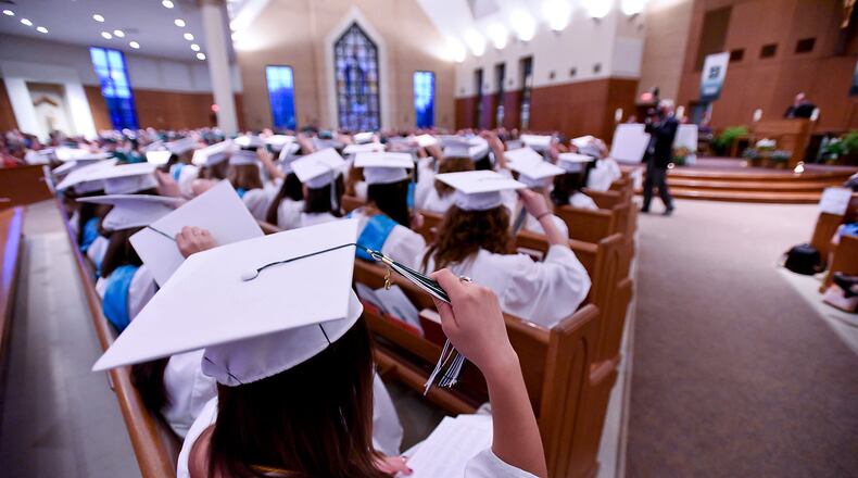 Graduating seniors across Butler County have until Jan. 7, 2024, to fill out the Hamilton Community Foundation's universal scholarship application. Pictured is a file photo from a previous Hamilton Badin graduation ceremony. In the file photo, Sarah Rieman and the rest of the 2015 graduation class move their tassels to the right during Stephen T. Badin High School's Forty-ninth Annual Commencement ceremony Friday, May 29, 2015, at St. Maximilian Kolbe Catholic Church in Liberty Township. NICK GRAHAM/FILE