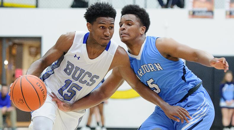 Xenia sophomore guard Samari Curtis dribbles with pressure from Fairborn’s Kermit Redmon during a Division I sectional semifinal last season at Centerville. Contributed Photo by Bryant Billing