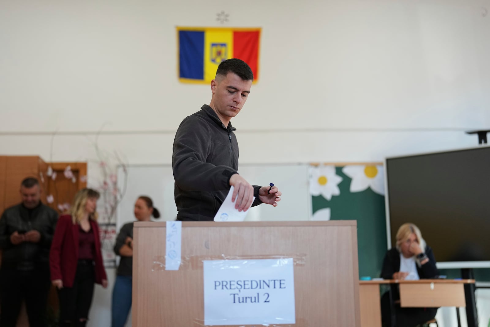 A man casts his vote in the second round of the country's presidential election redo in Mogosoaia, Romania, Sunday, May 18, 2025. (AP Photo/Andreea Alexandru)