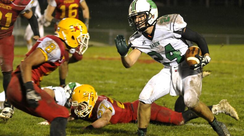 Badin’s Evan Grawe (24) attempts to evade Fenwick’s Giovanni DiGirolamo in the second quarter of last Friday’s game at Krusling Field in Middletown. The host Falcons won 27-9. CONTRIBUTED PHOTO BY DAVID A. MOODIE