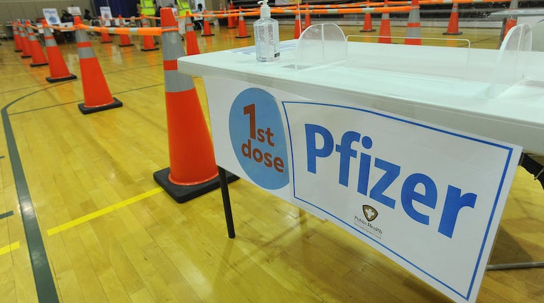 Members of  the Dayton & Montgomery County Public Health, prepare for the COVID-19 vaccination clinic Wednesday, April 28, 2021 at the Sinclair College Centerville, located at 5800 Clyo Rd. MARSHALL GORBY\STAFF