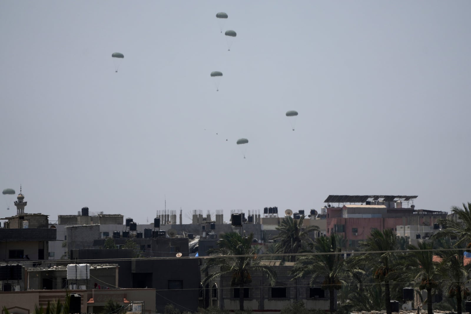 Humanitarian aid is airdropped to Palestinians over Deir al-Balah, central Gaza Strip Wednesday, July 30, 2025. (AP Photo/Abdel Kareem Hana)