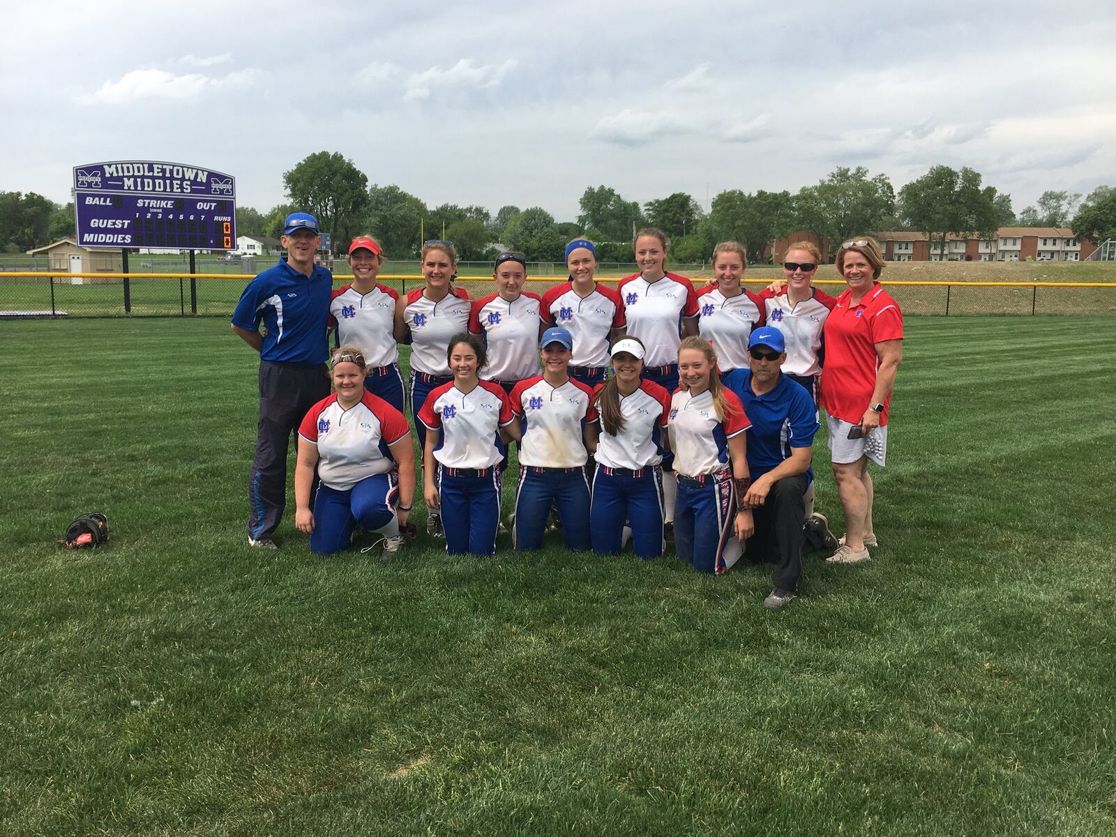 Clinton-Massie’s softball team poses for a photo Wednesday after defeating Monroe 12-2 in a Division II sectional final at Lefferson Park in Middletown. RICK CASSANO/STAFF