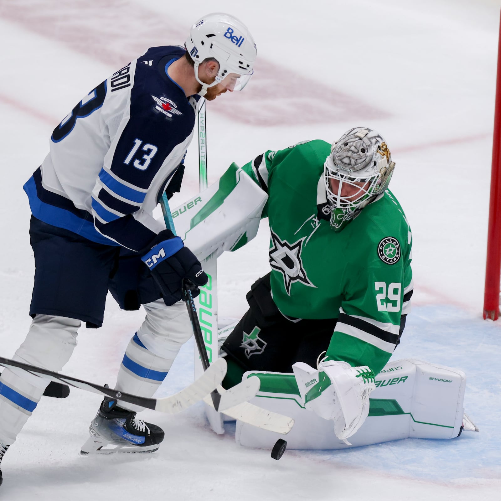 Dallas Stars goaltender Jake Oettinger (29) stops a shot from Winnipeg Jets center Gabriel Vilardi (13) in the third period of Game 4 of a second-round NHL hockey playoff series in Dallas, Tuesday, May 13, 2025. (AP Photo/Gareth Patterson)