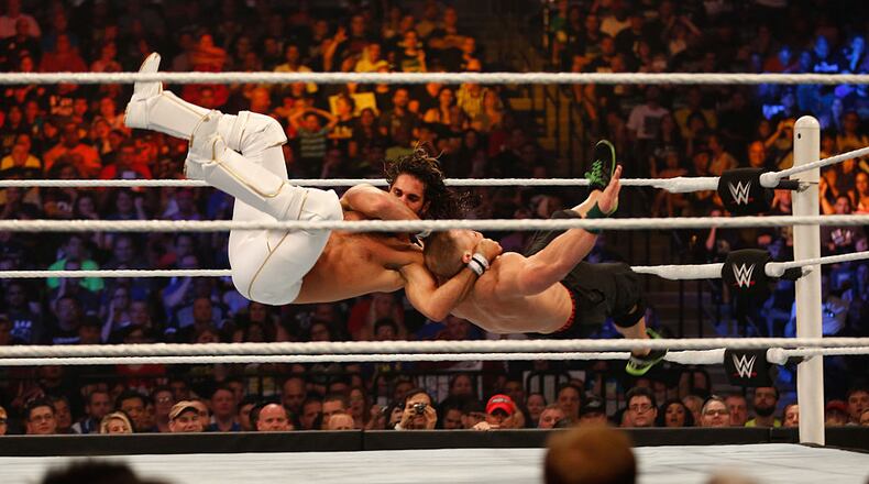 NEW YORK, NY - AUGUST 23: Seth Rollins and John Cena battle it out at the WWE SummerSlam 2015 at Barclays Center of Brooklyn on August 23, 2015 in New York City. (Photo by JP Yim/Getty Images)
