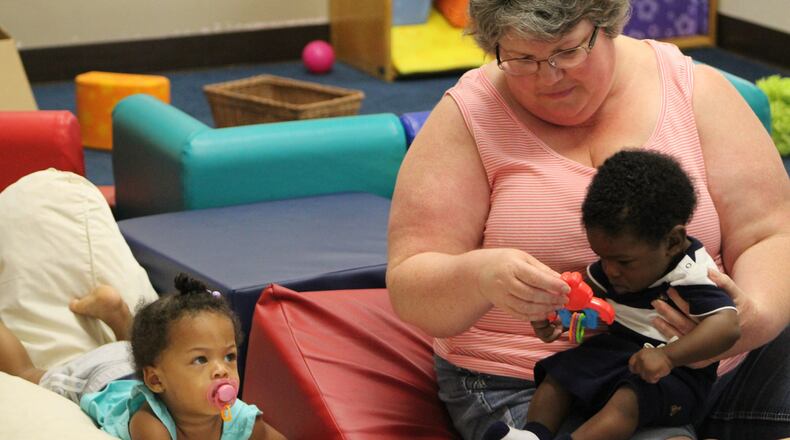About 80 children are enrolled at the Miami View Head Start Center on West Fifth St. in Dayton. Lead teacher Mitzi Ochs is seen here with 14-month-old Javayah Matthews and 5-month-old Logan Brown. CORNELIUS FROLIK / STAFF