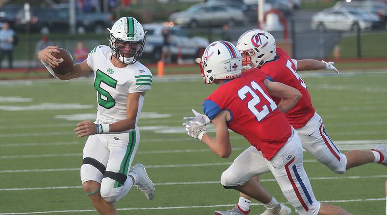 Badin's Landyn Vidourek tries to avoid a tackle by Carroll's Jack McGeady and Tristan Heasley. BILL LACKEY/STAFF