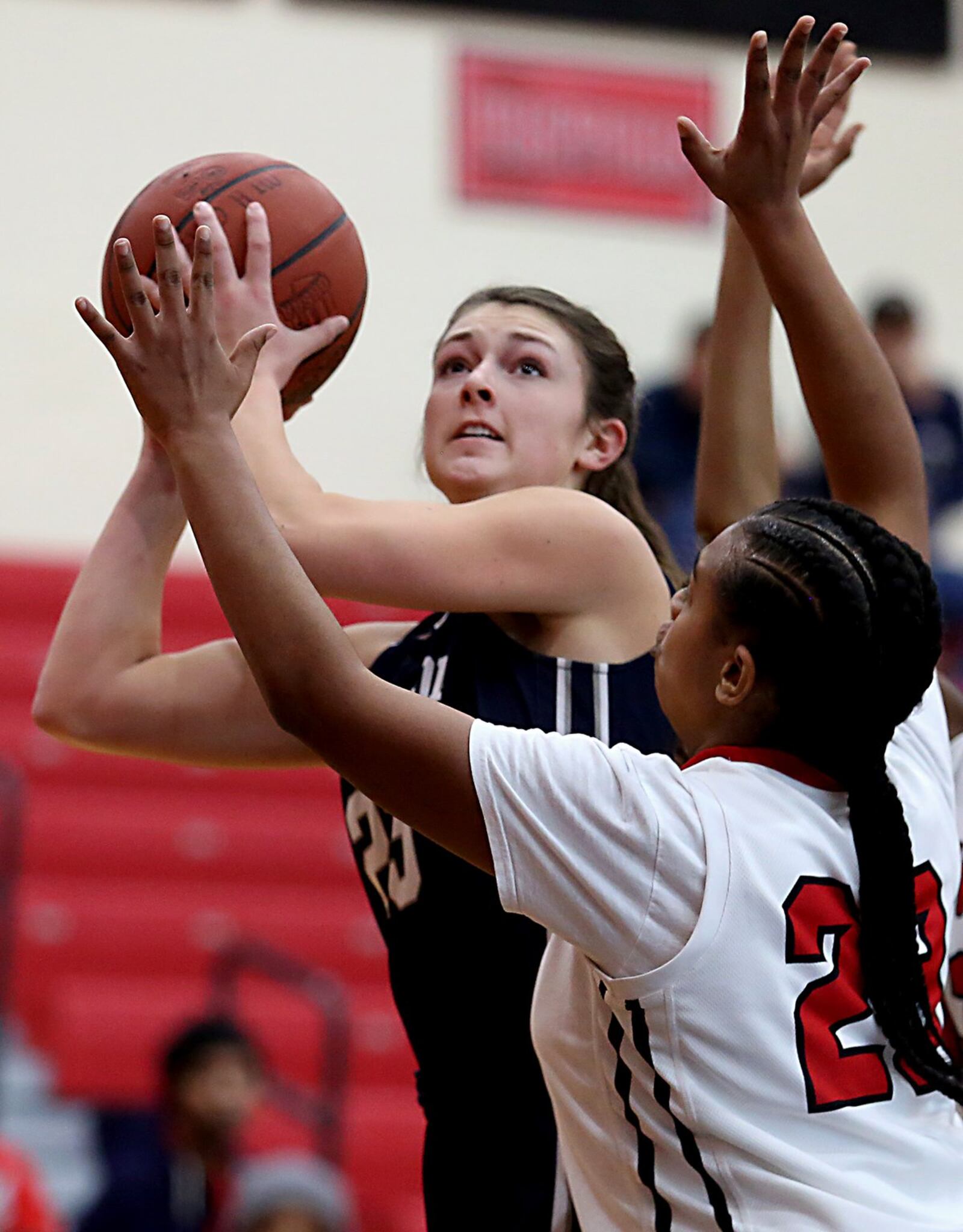Edgewood forward Sara Schaefer eyes the basket as Mt. Healthy’s Ebony Johnson (23) provides the defense Saturday afternoon at Mt. Healthy. CONTRIBUTED PHOTO BY E.L. HUBBARD