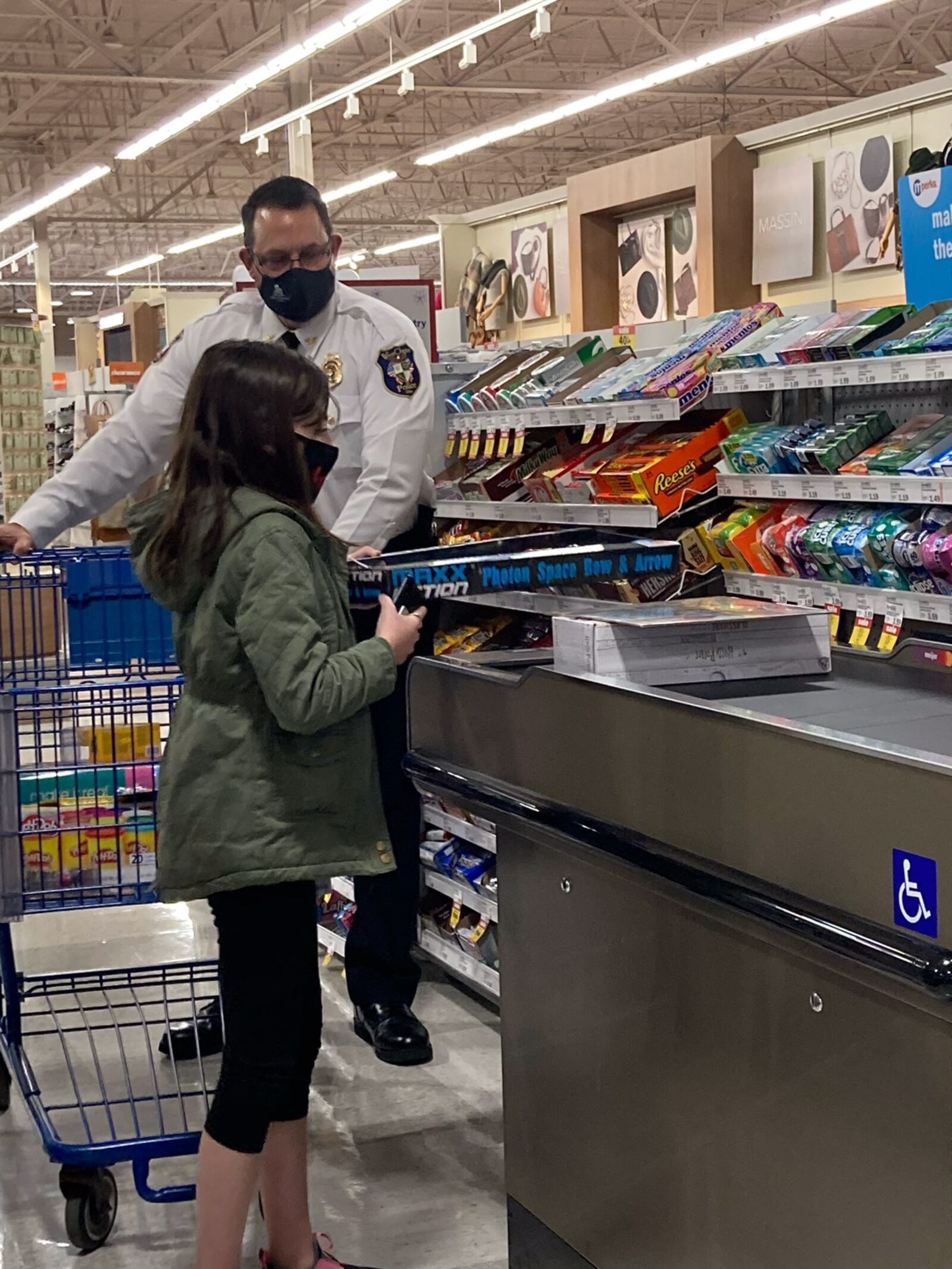 Members of the West Chester police department shopped with children at a local Meijer store this year. Instead of hosting a dinner for the families in the store, about 30 children received gift cards from White Castle. Police said this change was made due to the coronavirus. SUBMITTED PHOTO