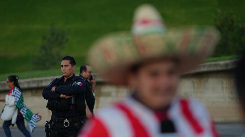A police officer stands guard outside Akron Stadium prior to a friendly match between Mexico and Ecuador in Guadalajara, Mexico, Tuesday, Oct. 14, 2025. (AP Photo/Eduardo Verdugo)