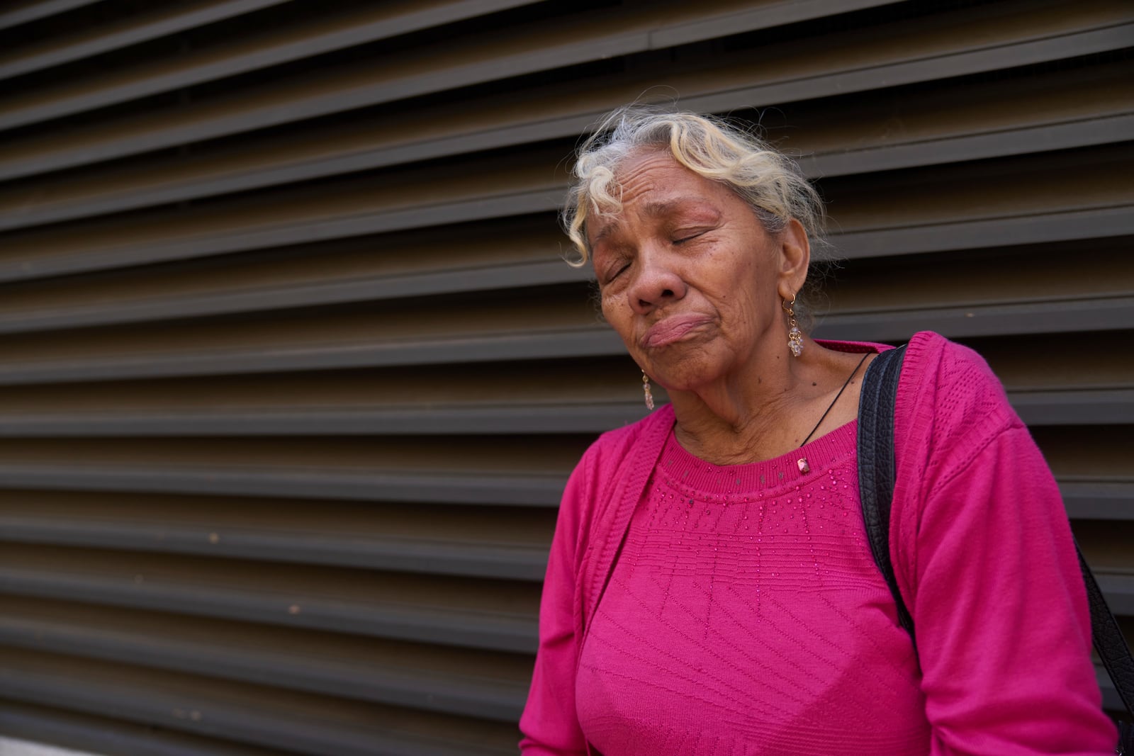 Yadira Almaraz, originally from Managua, Nicaragua, cries outside the ICE Los Angeles Staging Facility after visiting a young family member detained by federal agents in Los Angeles, on Wednesday, June 25, 2025. (AP Photo/Damian Dovarganes)