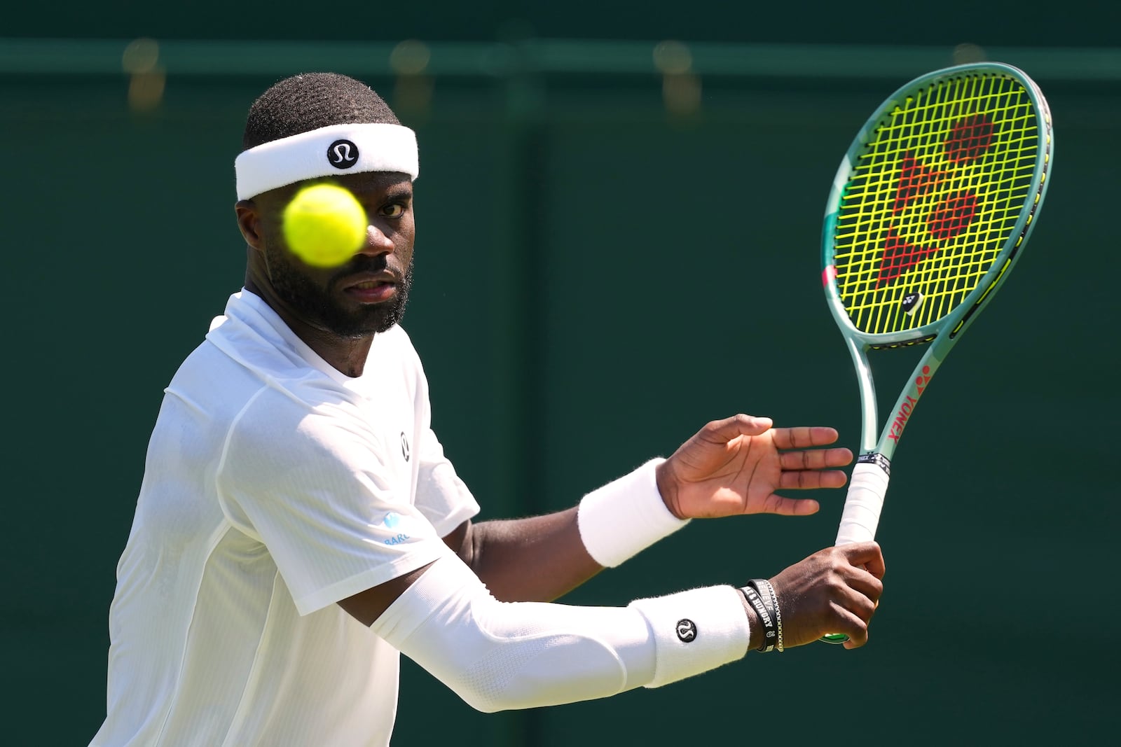 Frances Tiafoe of the U.S. returns the ball to Elmer Moller of Denmark during their first round men's single match at the Wimbledon Tennis Championships in London, Monday, June 30, 2025. (AP Photo/Kirsty Wigglesworth)