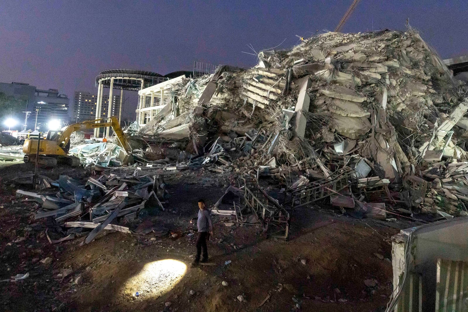 FILE- Rescuers search for victims at the site of a high-rise building under construction that collapsed after a strong earthquake in Bangkok, Thailand, early Saturday, March 29, 2025. (AP Photo/Wason Wanichakorn, File)