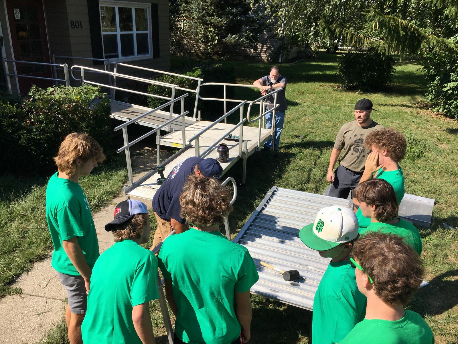 More than a half-dozen seniors from Hamilton's Badin High School spent most of Monday building a wheelchair ramp at the home of a Fairfield military veteran. The teen's community service project, which was coordinated through "Operation Ramp It Up," out of Liberty Twp., is one of the latest examples of the Catholic school's student program of philanthropy. (Photo By Michael D. Clark\Journal-News)