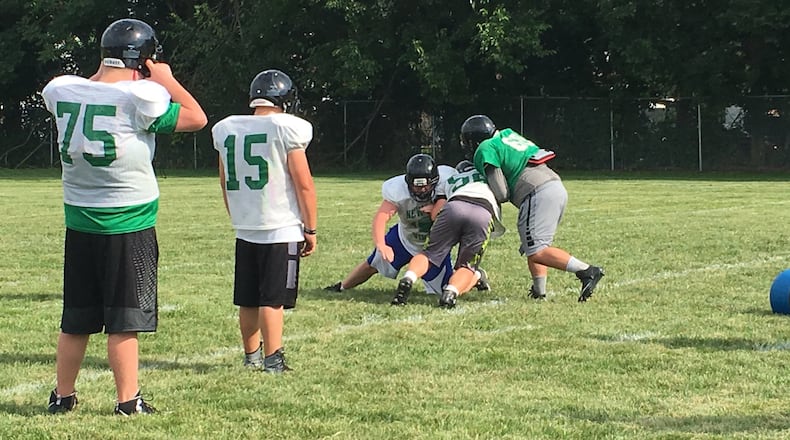 New Miami’s players run through drills during a recent practice at the high school. RICK CASSANO/STAFF