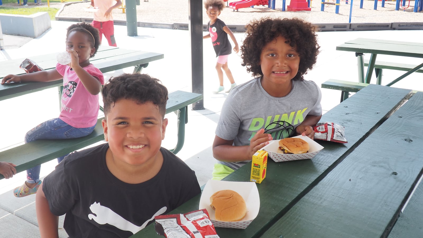 Kyrie, 9, and Dereck, 9, of Middletown enjoy burgers at Oakland Park's reopening community picnic. BRYN DIPPOLD/STAFF