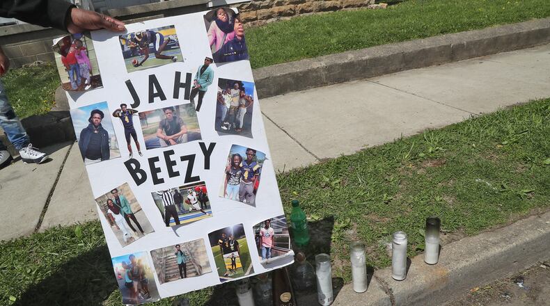 A memorial has started to form at the scene of a fatal mass shooting along Clifton Avenue Monday, May 2, 2022. One woman was killed and four others wounded in a shooting in front of 1227 Clifton Avenue early Sunday morning. BILL LACKEY/STAFF