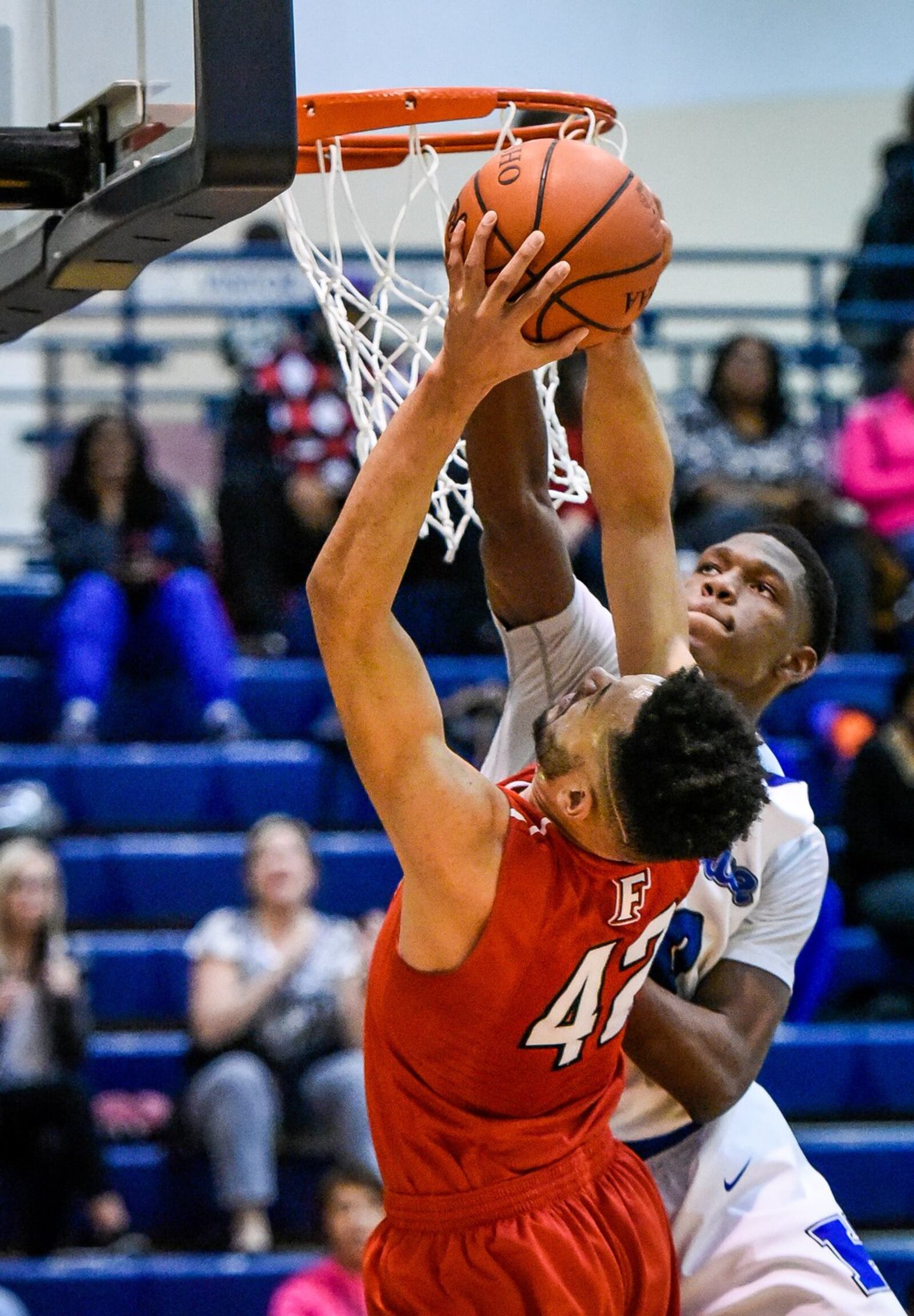 Hamilton’s Myles Howard denies a shot attempt by Fairfield’s Ben Phillips on Tuesday night at the Hamilton Athletic Center. NICK GRAHAM/STAFF